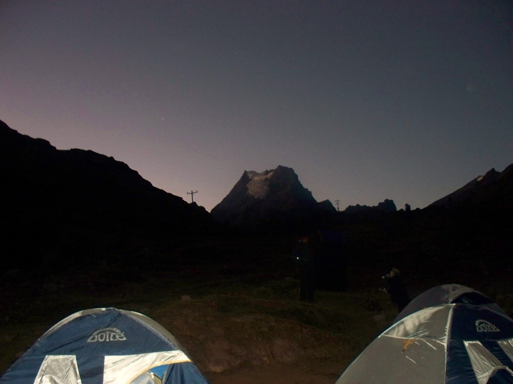 As the light begins to crack the night sky a nearby glacier shines above our resting place.