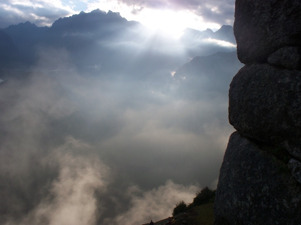 This is one of the pictures that I'm most proud of.  As all the people were focused on looking out at Wayna Picchu I turned to the right to see the sun breaking through over the mountains.  The rocks on the side are part of the watchtower of Machu Picchu which is one of the best places to watch the fog lift from the site itself.