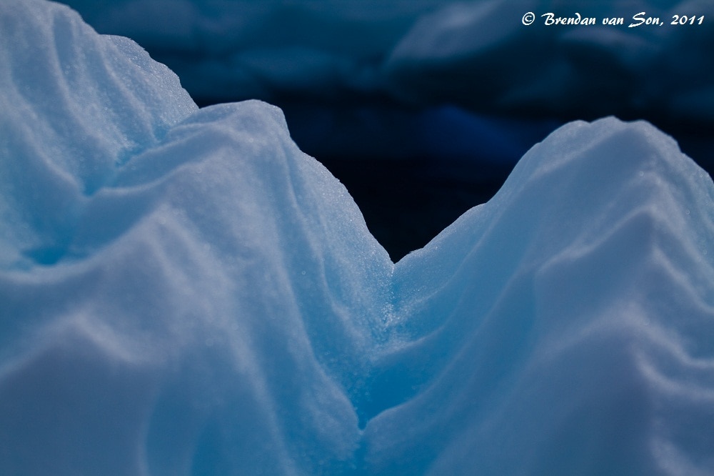 The bright blue in the ice is caused by light scattering, the same thing that makes our bright sky blue.